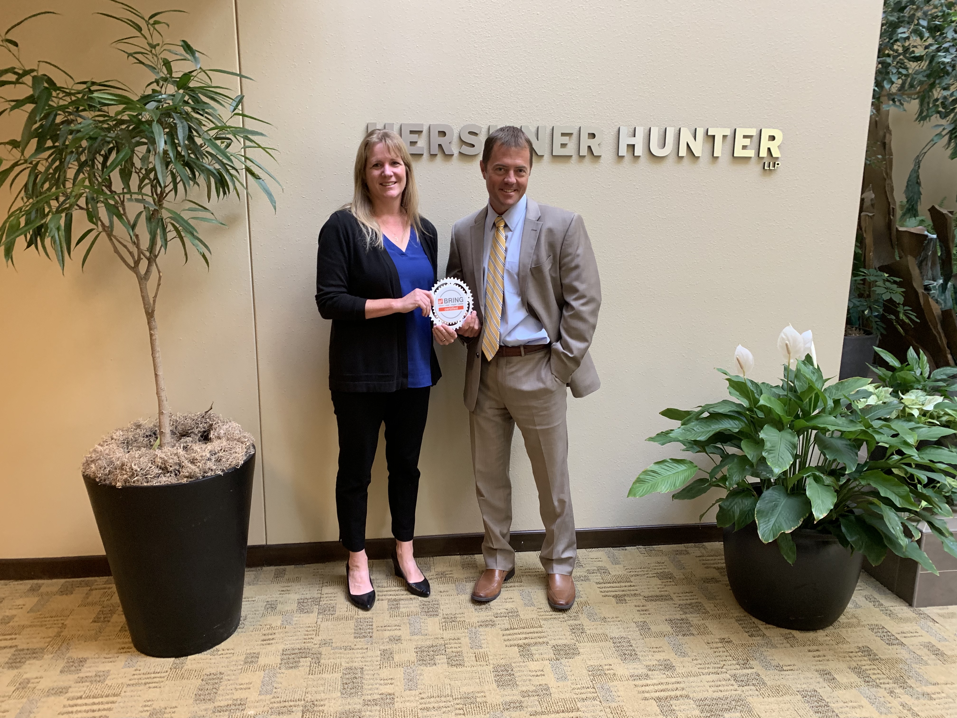 Partners Amanda Walkup (left) and Todd Johnston display Hershner Hunter's BRING Certification badge